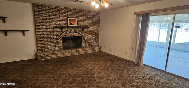 unfurnished living room featuring visible vents, carpet, a fireplace, a textured ceiling, and a ceiling fan