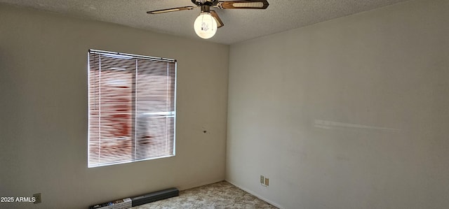 unfurnished room featuring a ceiling fan and a textured ceiling