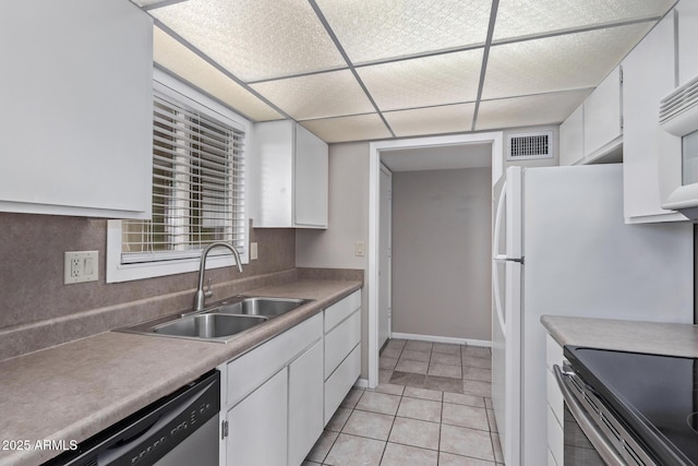 kitchen featuring sink, light tile patterned floors, white cabinetry, decorative backsplash, and stainless steel dishwasher