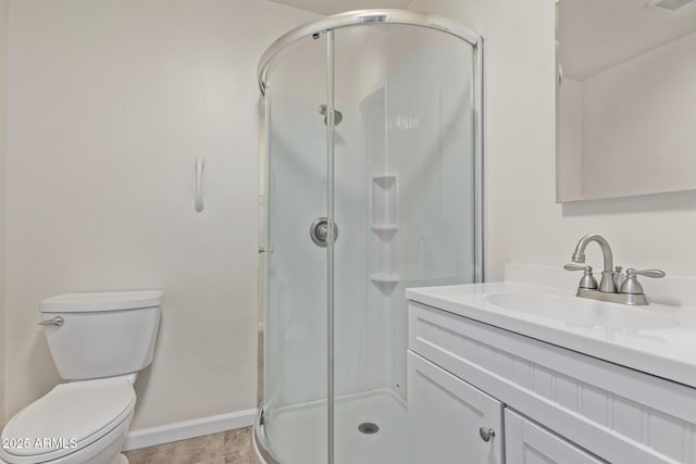 bathroom featuring a shower with door, vanity, and toilet