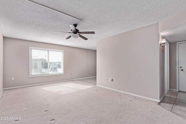 carpeted empty room with a textured ceiling and ceiling fan