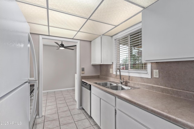 kitchen featuring sink, stainless steel dishwasher, white fridge, ceiling fan, and white cabinets