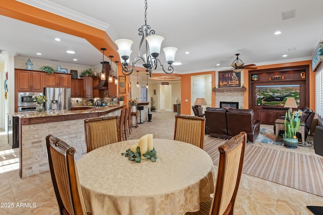 dining space featuring crown molding and ceiling fan with notable chandelier