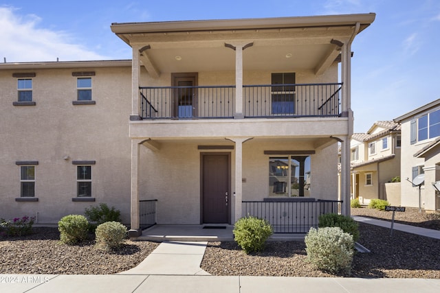 view of front of property featuring a balcony and covered porch