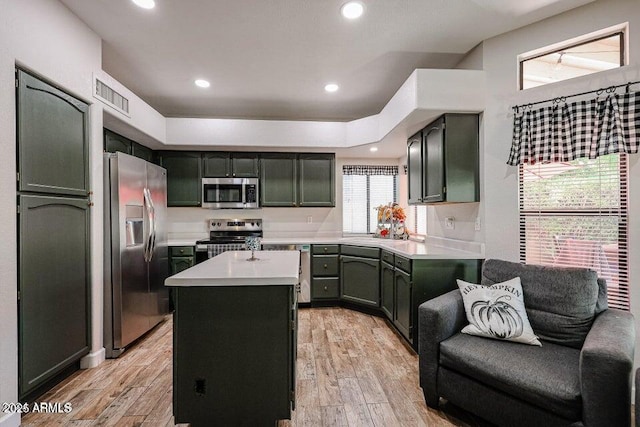 kitchen featuring sink, appliances with stainless steel finishes, and a center island