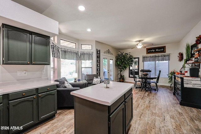 kitchen with a kitchen island, light hardwood / wood-style floors, and ceiling fan