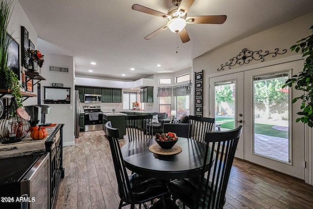 dining area featuring light hardwood / wood-style floors, a wealth of natural light, and french doors