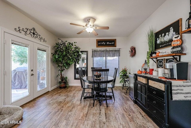 dining area with hardwood / wood-style flooring, ceiling fan, and french doors