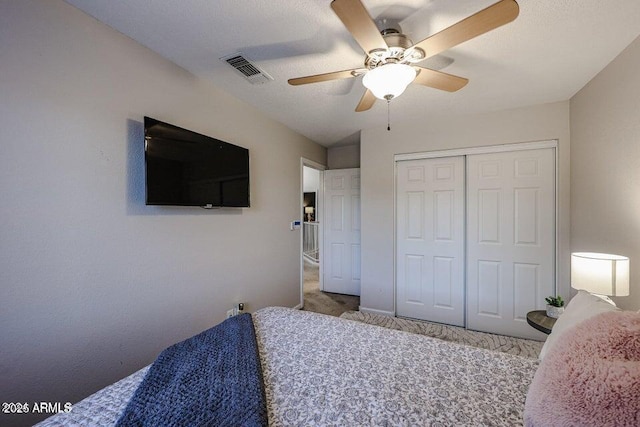 carpeted bedroom with a closet and ceiling fan