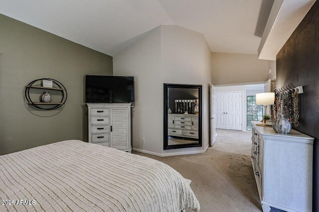 carpeted bedroom featuring lofted ceiling