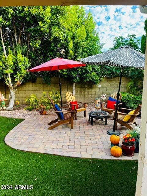 view of patio with an outdoor fire pit