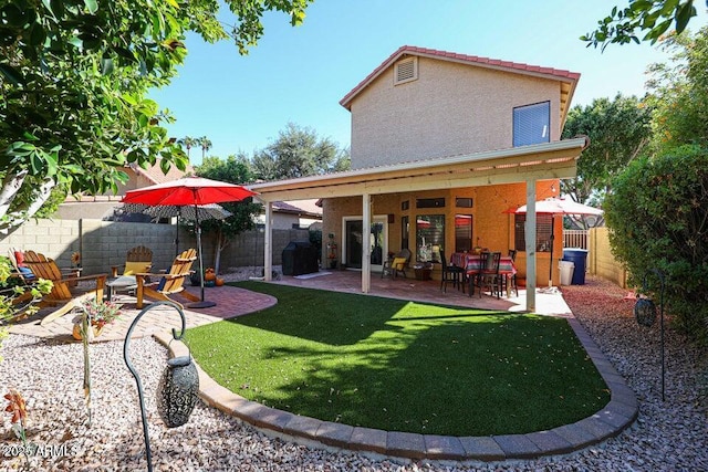 back of property featuring a patio and a lawn