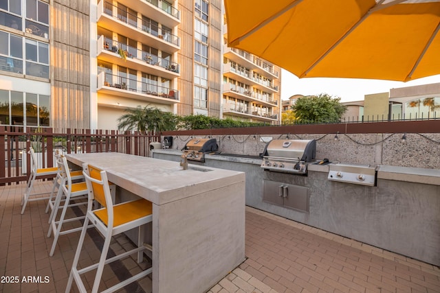 view of patio with a bar, grilling area, and exterior kitchen