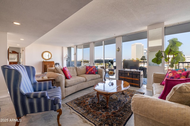 living room with light tile patterned floors, expansive windows, and a textured ceiling