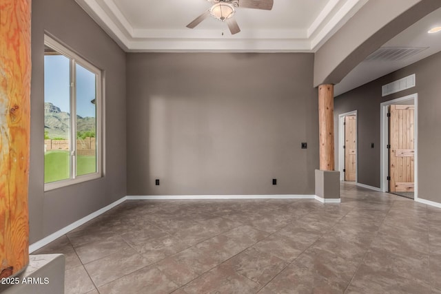 5347 E 10th Ave, Apache Junction, AZ 85119 - empty room with healthy amount of natural light, ceiling fan, a raised ceiling, and arched walkways