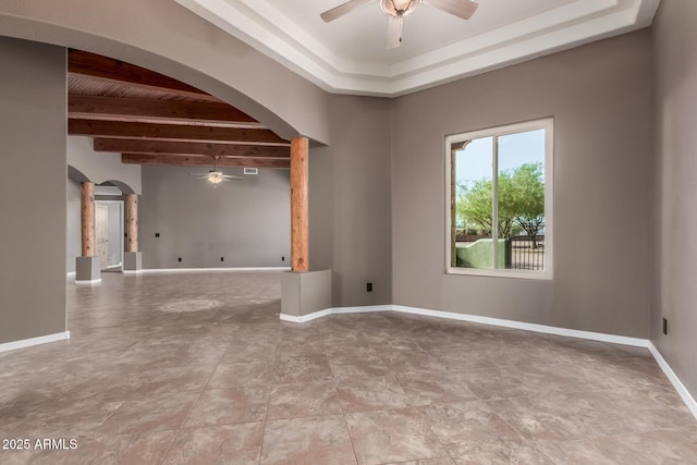 5347 E 10th Ave, Apache Junction, AZ 85119 - spare room featuring ceiling fan, arched walkways, a tray ceiling, and a wooden ceiling with exposed beams