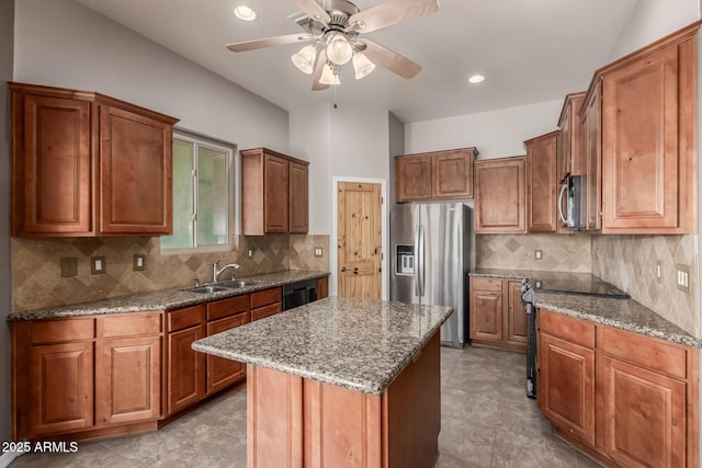 5347 E 10th Ave, Apache Junction, AZ 85119 - kitchen with appliances with stainless steel finishes, stone counters, ceiling fan, a center island, and brown cabinetry