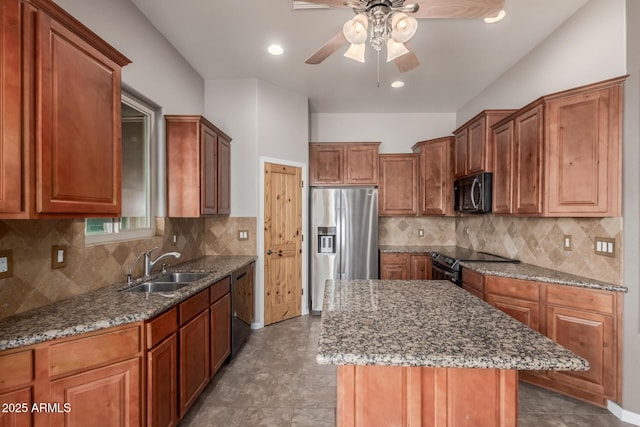 5347 E 10th Ave, Apache Junction, AZ 85119 - kitchen with black appliances, ceiling fan, dark stone counters, a center island, and tasteful backsplash