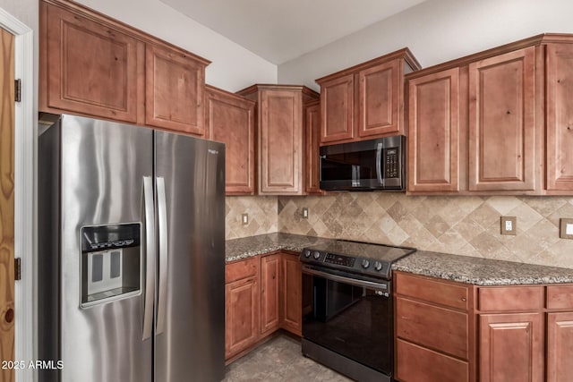 5347 E 10th Ave, Apache Junction, AZ 85119 - kitchen featuring stainless steel appliances, dark stone countertops, brown cabinets, and backsplash