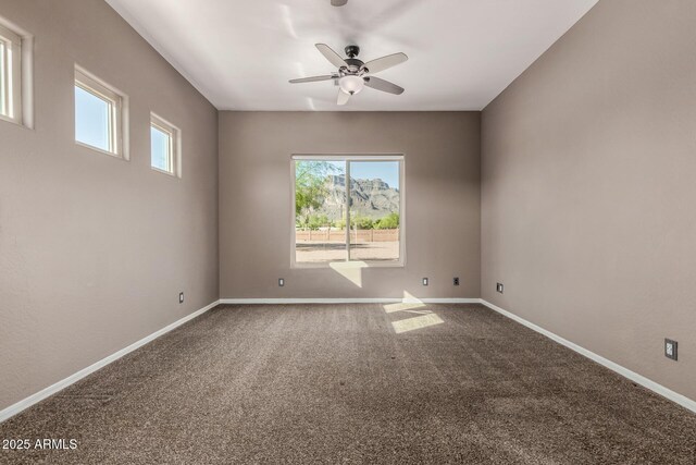 5347 E 10th Ave, Apache Junction, AZ 85119 - empty room featuring plenty of natural light, carpet flooring, and a ceiling fan