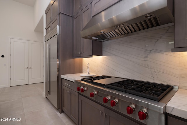 kitchen with range hood, appliances with stainless steel finishes, decorative backsplash, and light tile patterned floors