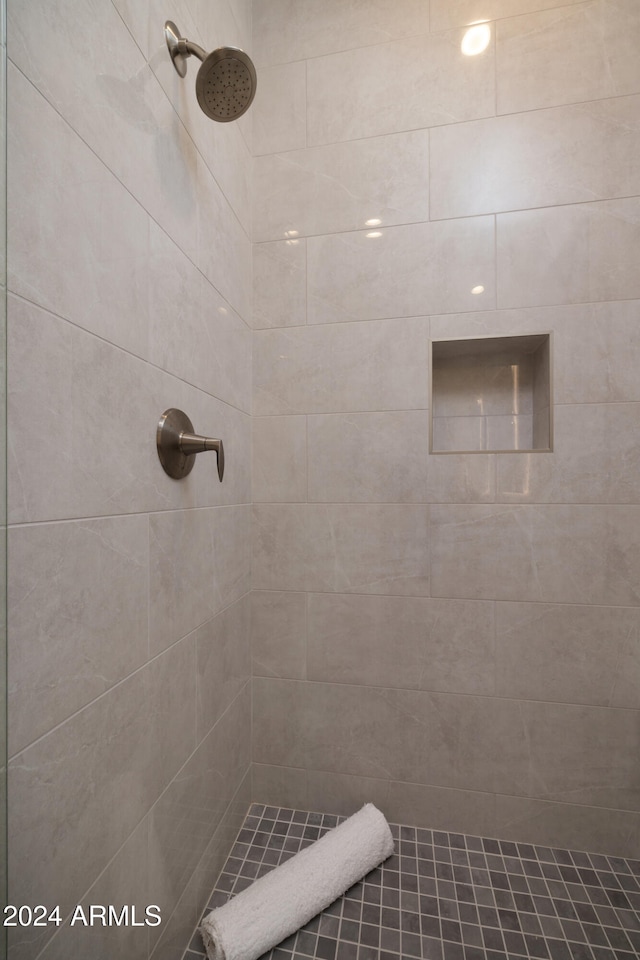 bathroom with tiled shower