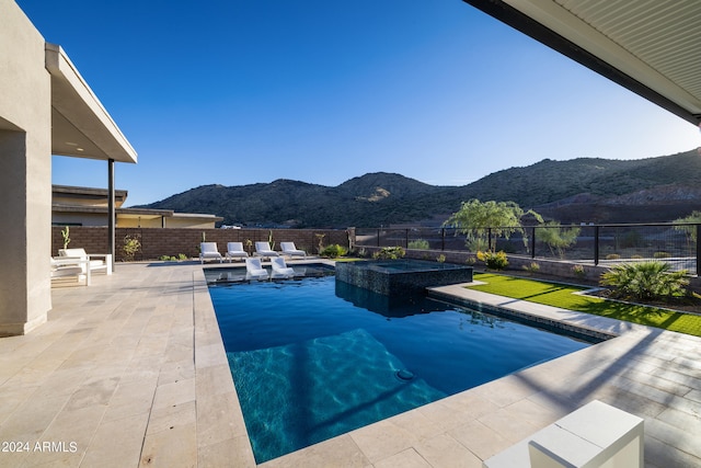 view of pool featuring a mountain view and a patio