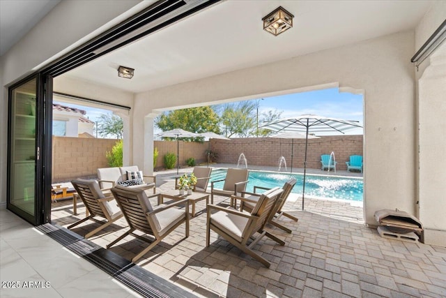 view of patio featuring a fenced in pool and pool water feature