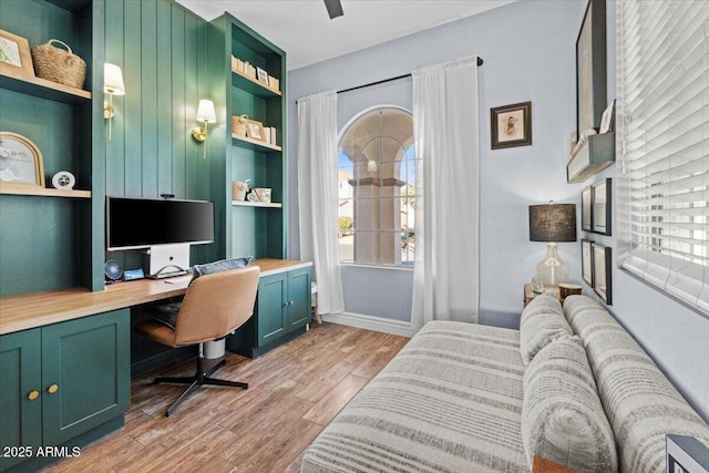 office area with light hardwood / wood-style flooring and built in desk