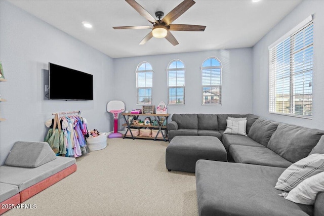 carpeted living room featuring ceiling fan and plenty of natural light