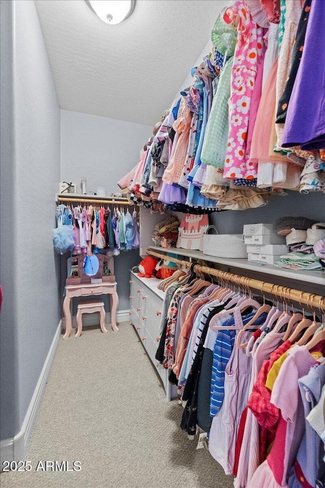 walk in closet with carpet floors