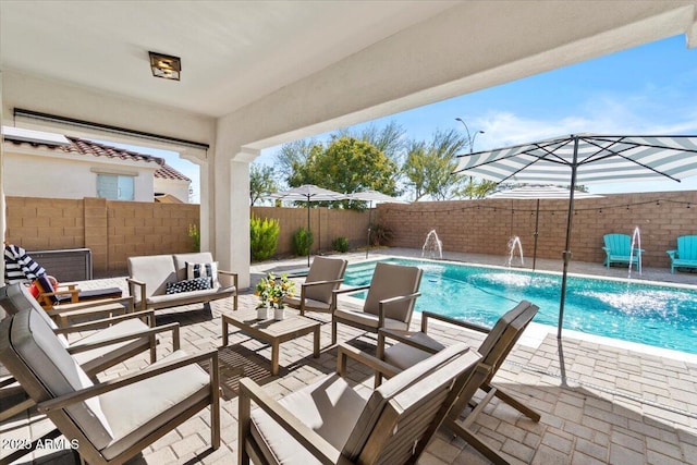 view of pool with pool water feature, a patio area, and outdoor lounge area