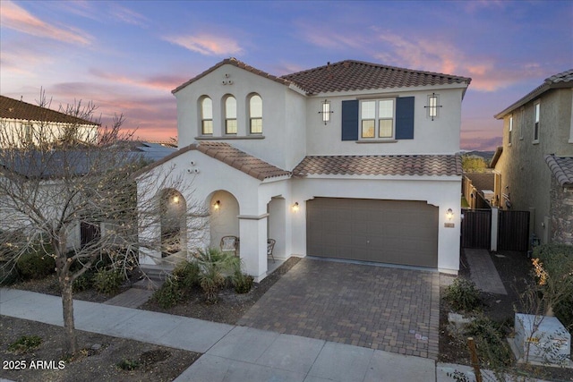 mediterranean / spanish-style house with a garage