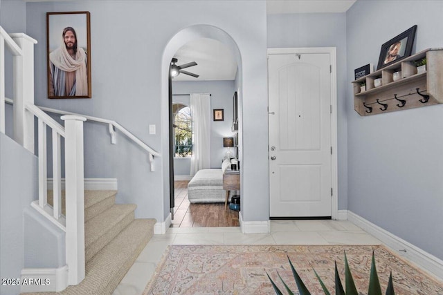 tiled foyer entrance featuring ceiling fan