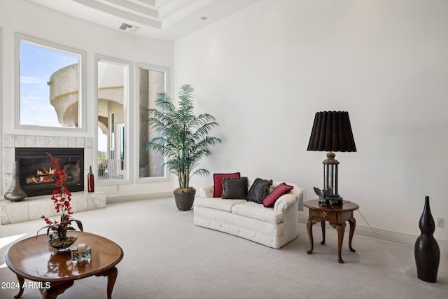 living room with carpet floors and a tile fireplace