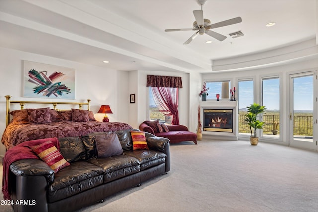 bedroom with access to outside, multiple windows, ceiling fan, and carpet