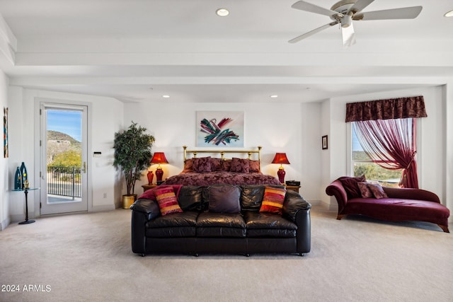 carpeted living room with ceiling fan