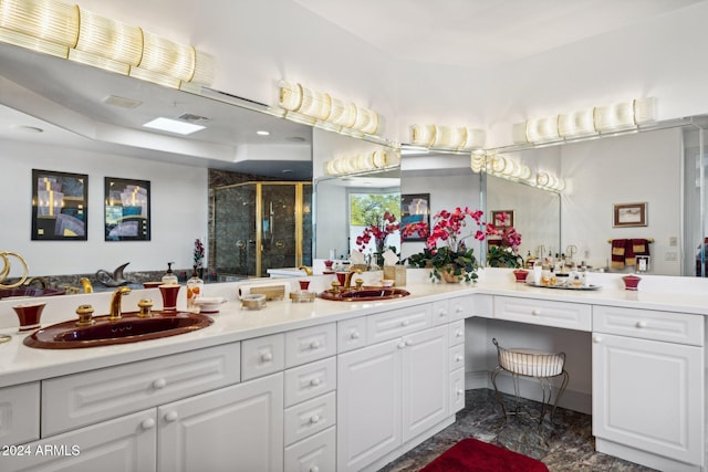 bathroom with a shower with door and vanity