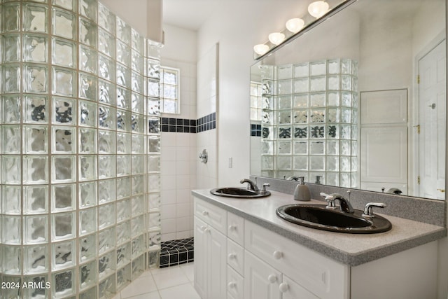 bathroom featuring tile patterned floors, vanity, and walk in shower