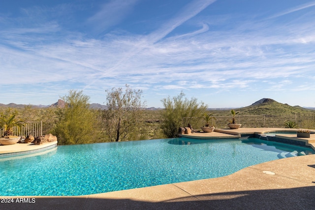 view of pool with a mountain view and a patio