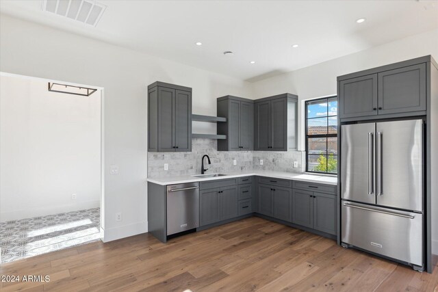 kitchen featuring appliances with stainless steel finishes, gray cabinets, and dark hardwood / wood-style flooring