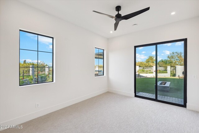 carpeted empty room with ceiling fan