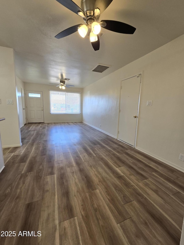 unfurnished room with ceiling fan and dark wood-type flooring