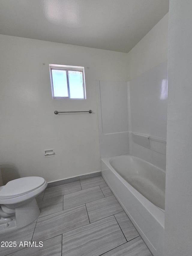 bathroom featuring toilet and shower / bath combination