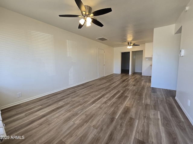 unfurnished living room featuring ceiling fan and dark hardwood / wood-style flooring