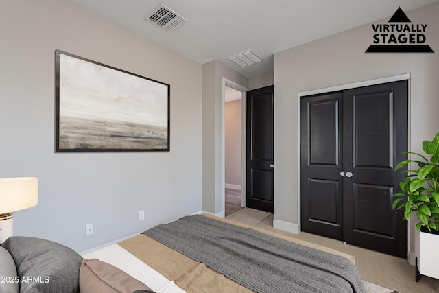 carpeted bedroom with baseboards and a closet