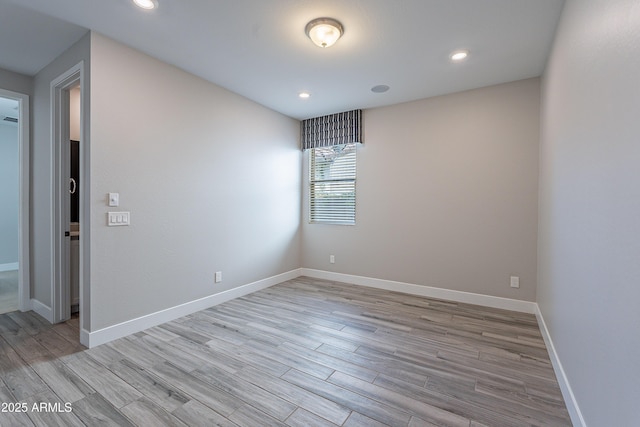 unfurnished room featuring light wood-style floors, baseboards, and recessed lighting