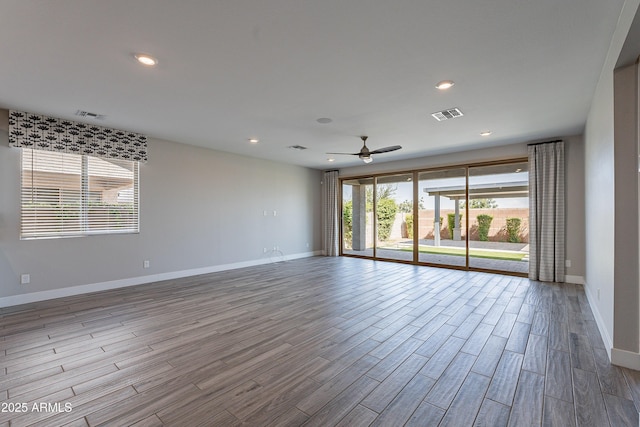 unfurnished room featuring baseboards, wood finished floors, ceiling fan, and recessed lighting