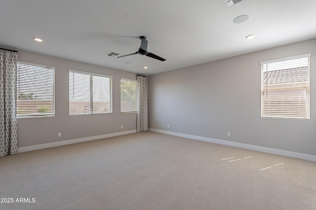 unfurnished room with ceiling fan, light colored carpet, baseboards, and recessed lighting