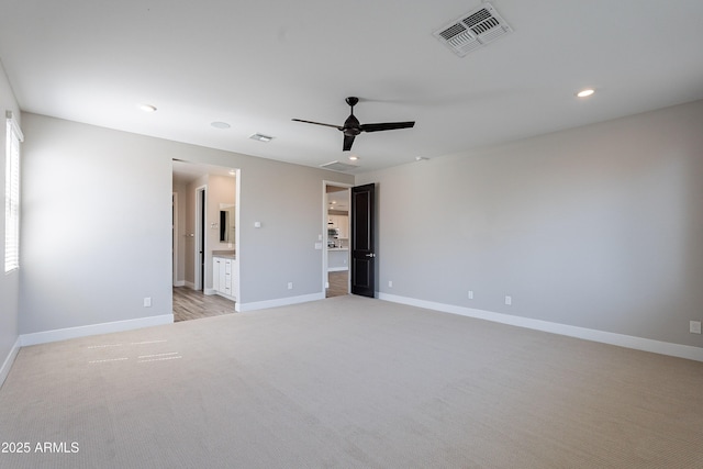 spare room with light carpet, recessed lighting, baseboards, and ceiling fan